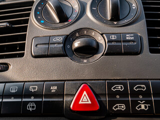 Plastic car control panel with buttons and knobs. Car air conditioner adjustment. Air flow in the...