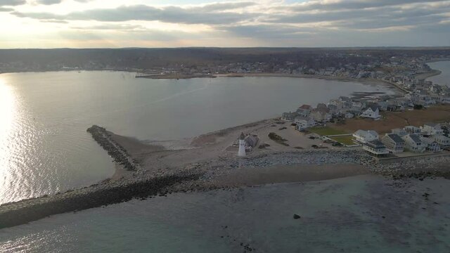 Scituate Lighthouse - Massachusetts - An orbital aerial shot around a lighthouse in New England around sundown.