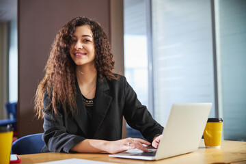 Attractive young woman working on notebook in office