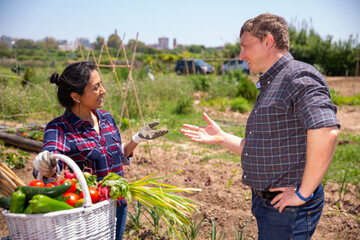 Conversation of good neighbors during meeting on farm field