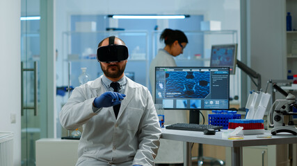 Professional scientist using medical inovation in lab wearing virtual reality glasses,...