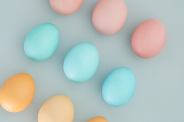 Blue, yellow and pink Easter eggs on a pastel blue background. Easter background, easter concept, top view, flat lay