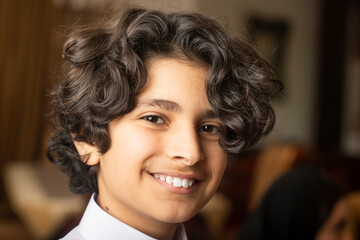 Young arabian boy smiling at home