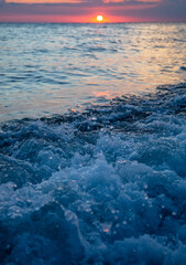 Water by the sea at sunset.