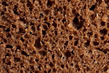 Black rye bread as background.