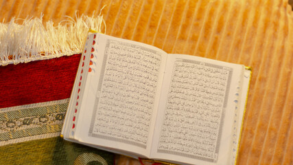 Al-Quran book and prayer mats background
