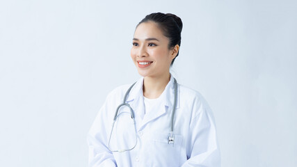 Portrait of smiling young asian female doctor in a background for your text.