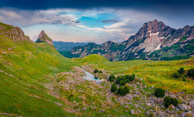 Naklejka na ściany i meble Beautiful summer scenery. Amazing morning view of mountain valley from Sedlo pass. Picturesque summer scene of Durmitor National Prk, Montenegro, Europe. Beauty of nature concept background..