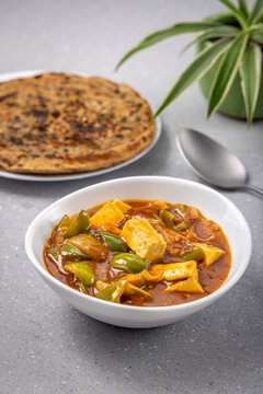 chilli paneer with lacha paratha served for the meal