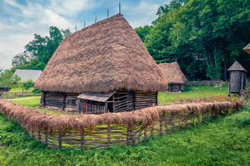Fototapeta na wymiar Panoramic summer view of traditional romanian peasant houses. Stunning rural scene of Transylvania, Romania, Europe. Beauty of countryside concept background.