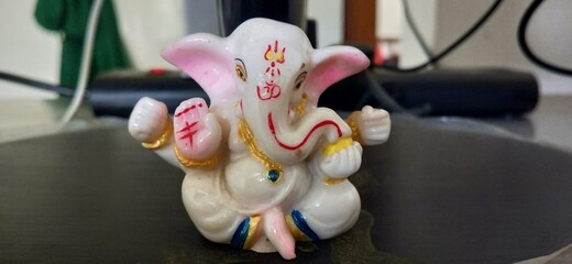 cute white color small Ganesh statue with modak 