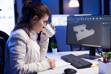 Software engineer working at digital cad project late at night in office company. Woman...
