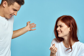 Cheerful young couple in white t-shirts hugs parents emotions fun communication