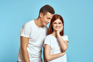 Cheerful young couple in white t-shirts hugs parents emotions fun communication