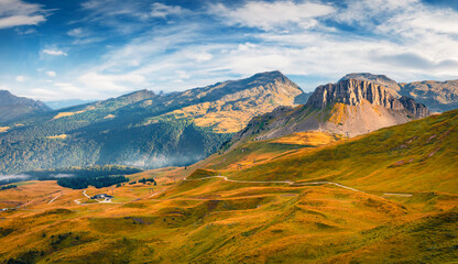 Beautiful autumn scenery. Breathtaking morning view of the top of Rolle pass. Nice autumn scene of Dolomite Alps. Colorful landscape of mountain valley, Trentino province, Italy, Europe. © Andrew Mayovskyy