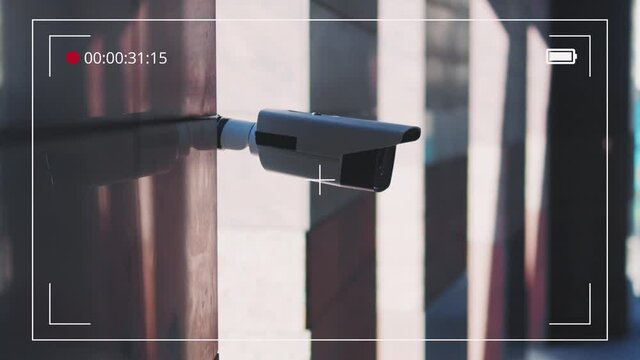 Shot of record screen with security camera moving recording outside a building at sunlight. CCTV surveillance. Privacy, urban, protection, house, system, control, secure, view, safe, video. Slow