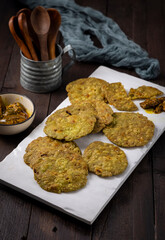 crispy and salty mathri with mango pickle on a white tray