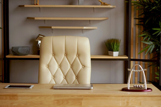 A  cozy workplace in a home office with a white leather office chair