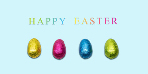 Happy Easter card with wrapped chocolate eggs on blue background. Minimal design.