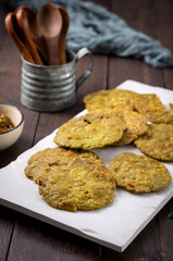 crispy and salty mathri with mango pickle on a white tray
