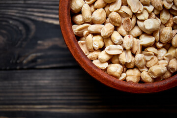 Nuts bowl on wooden background. Healthy vegan food.
