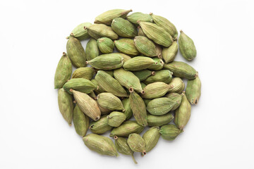 Fototapeta premium Macro close-up of Organic Cardamom or cardamum (Elettaria cardamomum) on white background. Pile of Indian Aromatic Spice. Top view