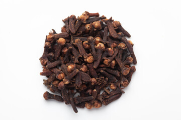 Macro close-up of Organic Clove (Syzygium aromaticum) or Indian long on white background. Pile of Indian Aromatic Spice. 