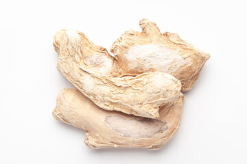 Macro close-up of Organic dry Ginger root (Zingiber officinale) or sonth on white background. Pile...