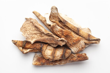 Macro close-up of Organic dried mango slices (Mangifera indica) or amchoor on white background....
