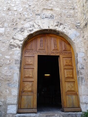 old wooden arch door with middle open of a church