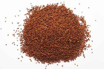 Macro close-up of Organic red-brown small mustard seed (Brassica nigra)  on white background. Pile of Indian Aromatic Spice. 