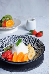 a bowl of shaved ice with various fruits
