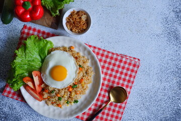 a plate of fried rice with vegetables and egg 