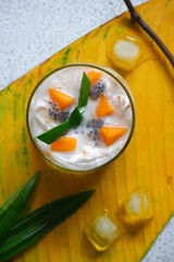 a glass of coconut and mango drinks 