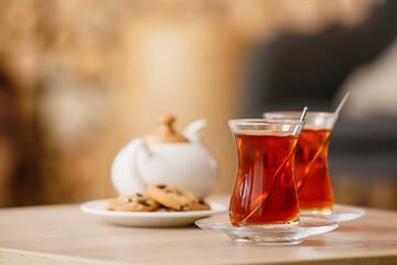 Cups of hot tea on table