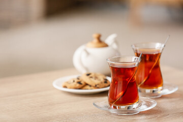 Cups of hot tea on table