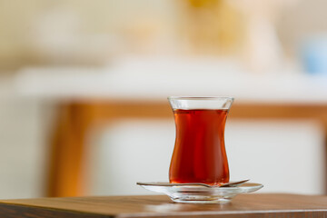 Cup of hot tea on table