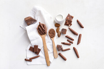 Chocolate pieces and curls on white background