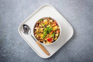 black gram or kala chana chaat with boiled potato, onion, tomato with a dash of lemon juice served on a white bowl