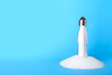 Saltcellar and salt on color background