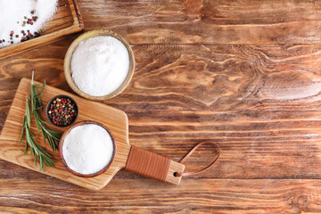 Fototapeta na wymiar Bowls of salt on wooden background