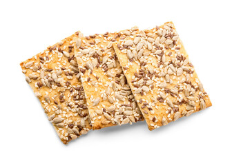 Tasty crackers with seeds on white background