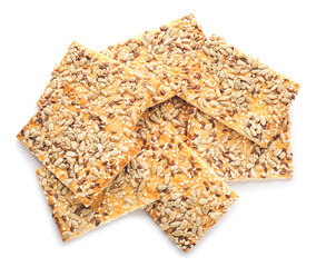 Tasty crackers with seeds on white background