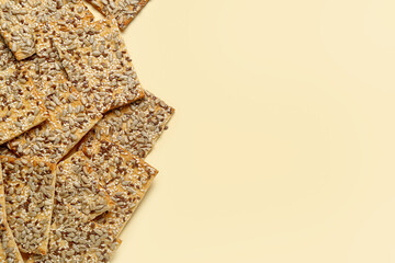 Tasty crackers with seeds on color background