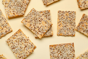 Tasty crackers with seeds on color background