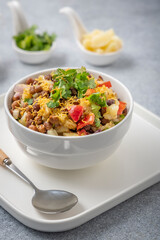 black gram or kala chana chaat with boiled potato, onion, tomato with a dash of lemon juice served on a white bowl