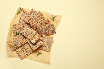 Tasty crackers with seeds on color background