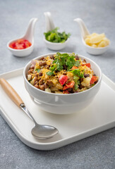 black gram or kala chana chaat with boiled potato, onion, tomato with a dash of lemon juice served on a white bowl