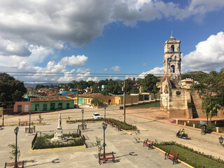 Aerial view of the square and Church of Santa Ana, in Trinidad, with the  typical colored colonial houses of the city.