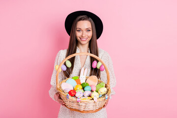 Photo of charming sweet young lady wear white outfit cap holding easter bucket isolated pink color...
